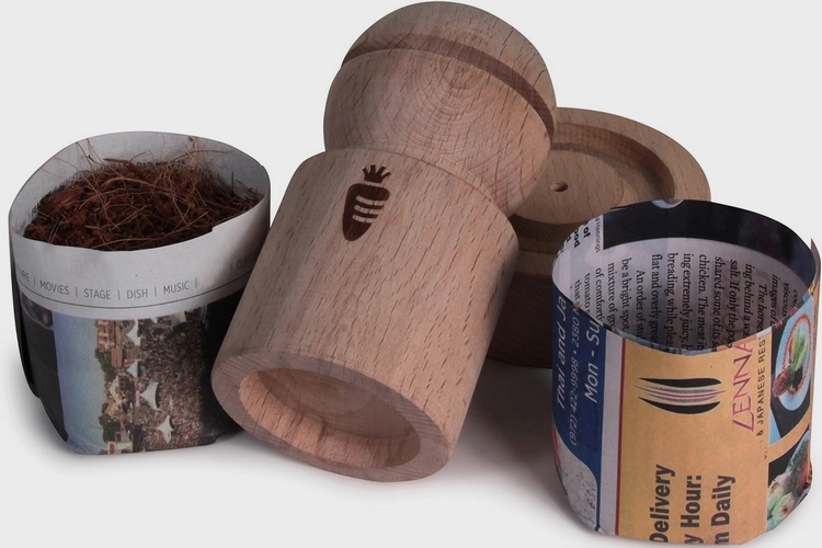 https://www.coolthings.com/wp-content/uploads/2023/12/the-best-gardening-gifts-02-carrot-design-newspaper-pot-maker.jpg